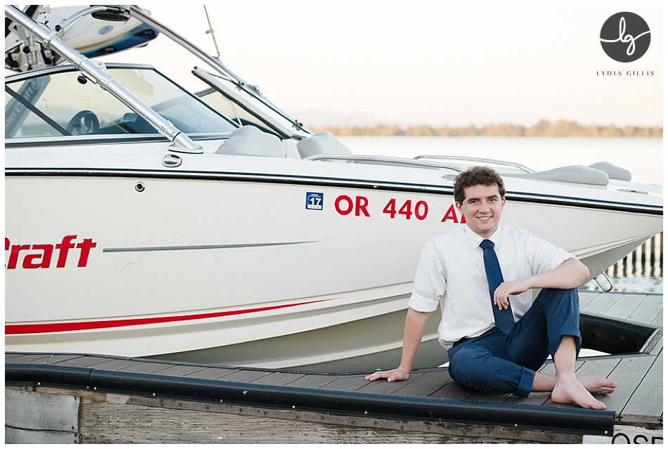 Senior pictures of boy on a boat